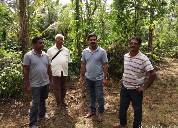 C. Shivaprasad with growers in a plantation