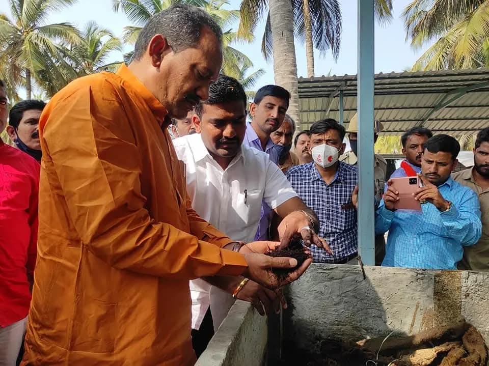 Inspecting a compost bed at a community event
